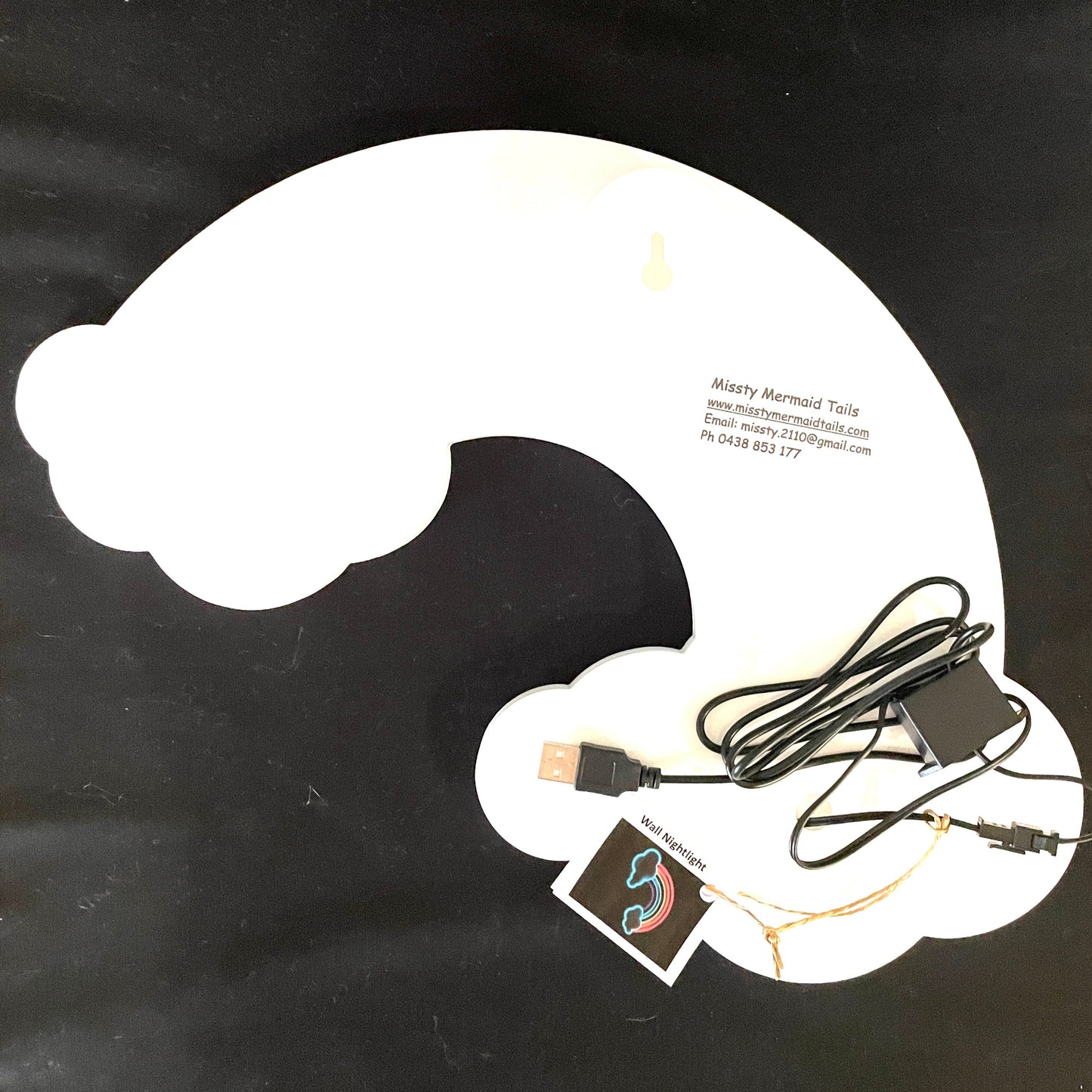Back view of rainbow and cloud neon light with a USB lead