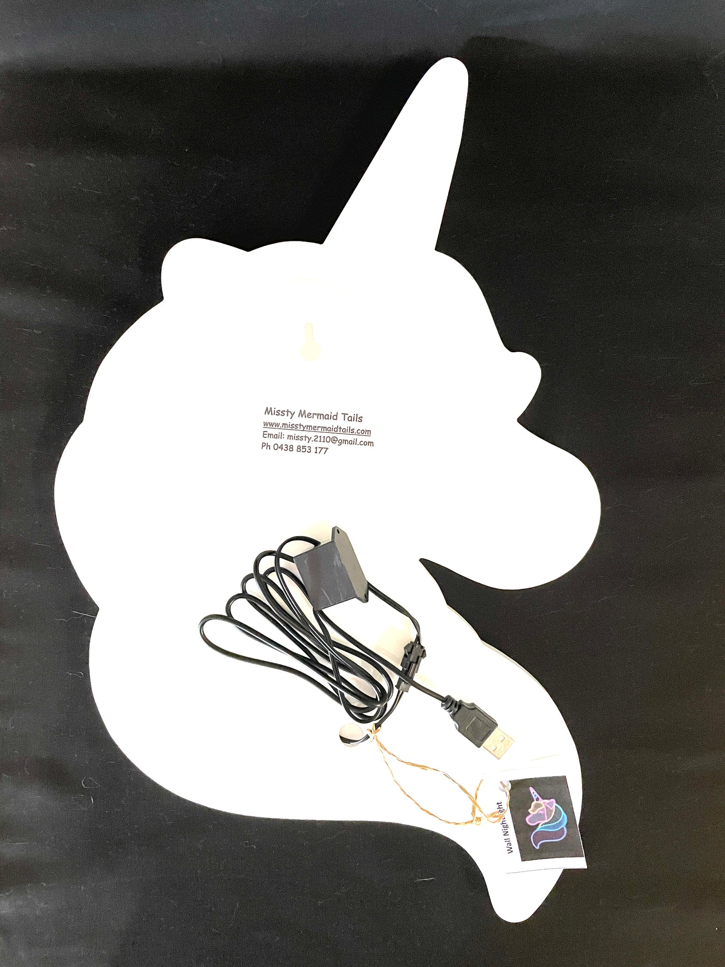 Back view of unicorn neon light with USB lead