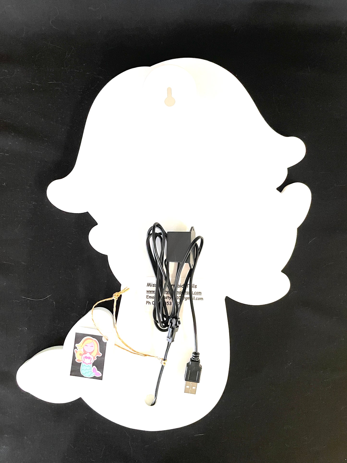 Back view of mermaid neon light with a USB lead