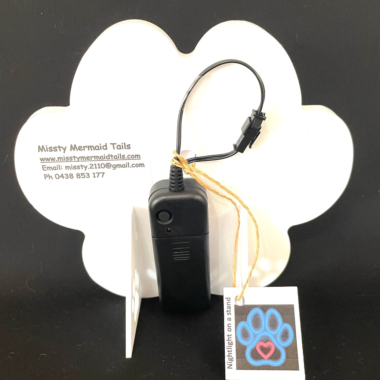Back view of paw print neon light with a battery pack