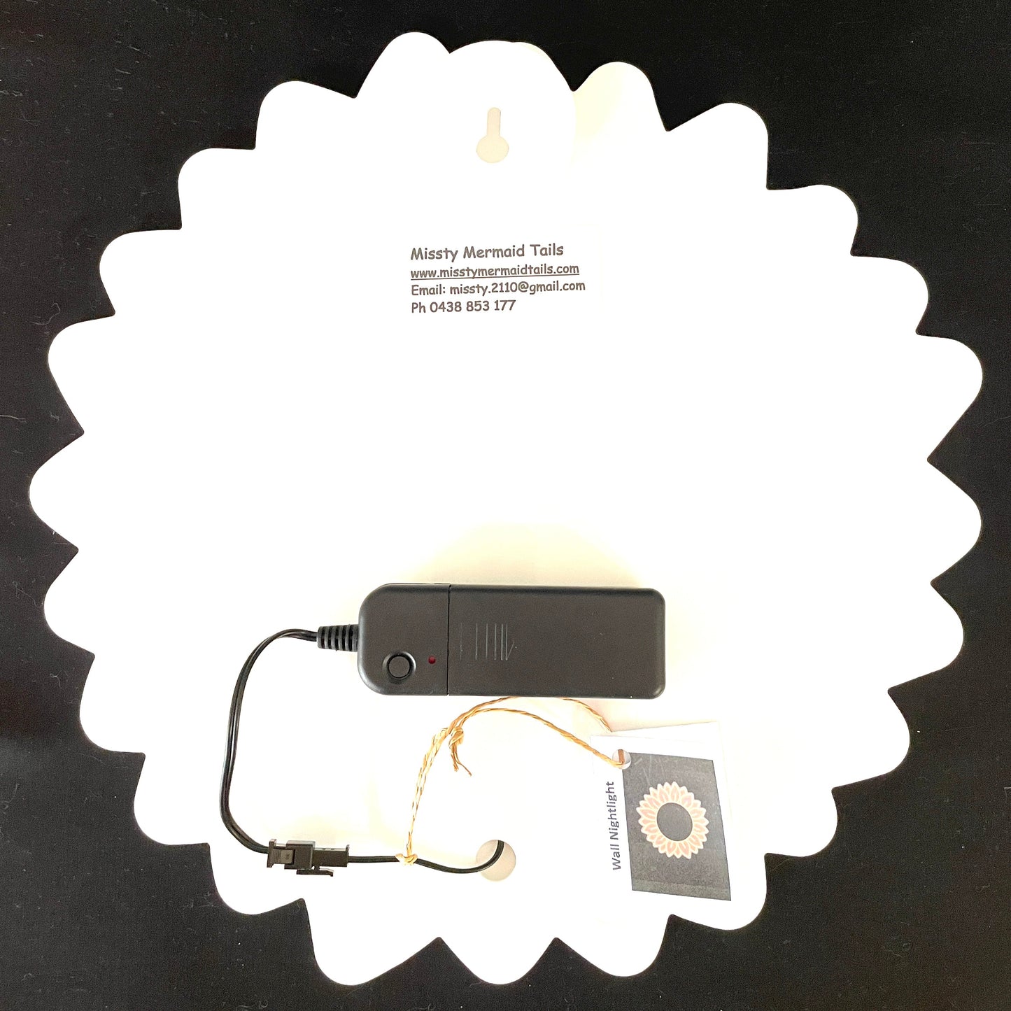 Back view of sunflower neon light with a battery pack