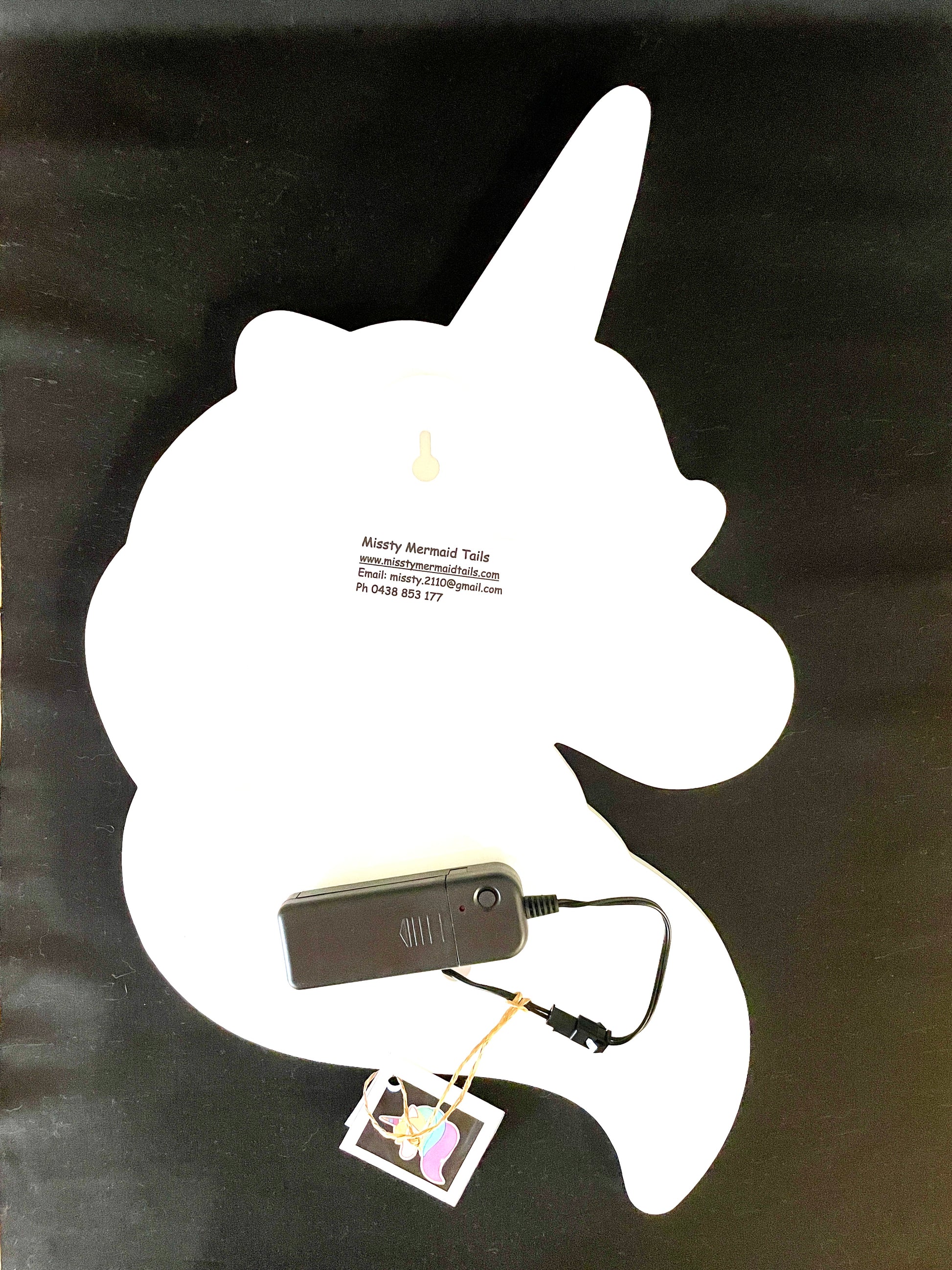 Back view of unicorn neon light with battery pack