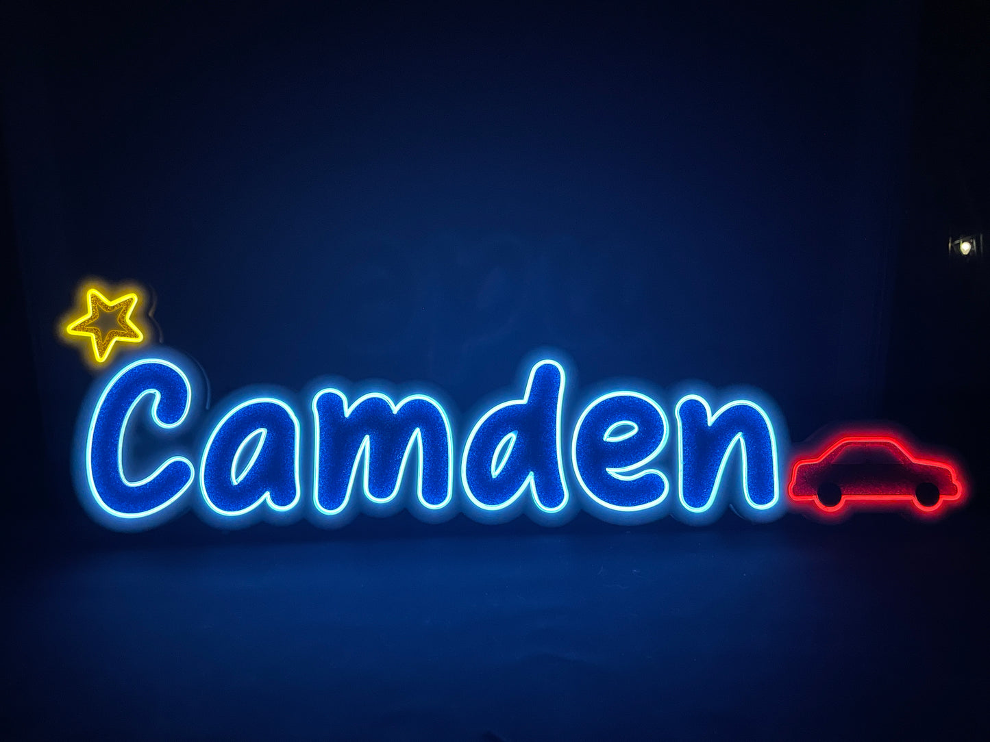 Camden neon name light in blue with a Star at the beginning and a red car at the end displayed let up