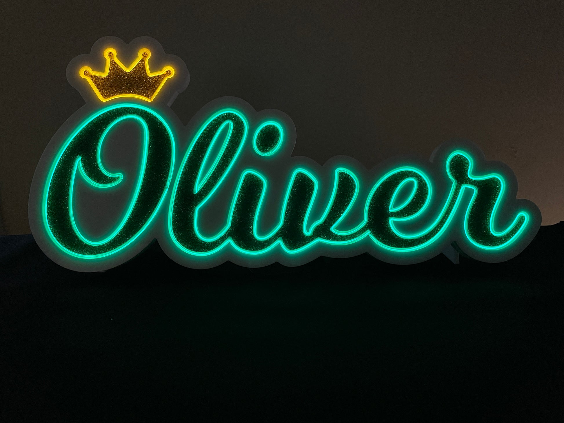 Oliver neon name light in green with a gold crown displayed lit up