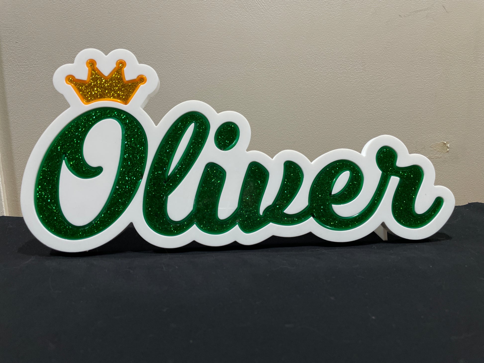 Oliver neon name light in green with a gold crown displayed  not lit up