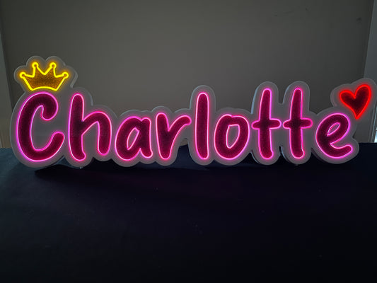 Charlotte neon name light in pink with a gold crown at the beginning and a heart at the end displayed lit up