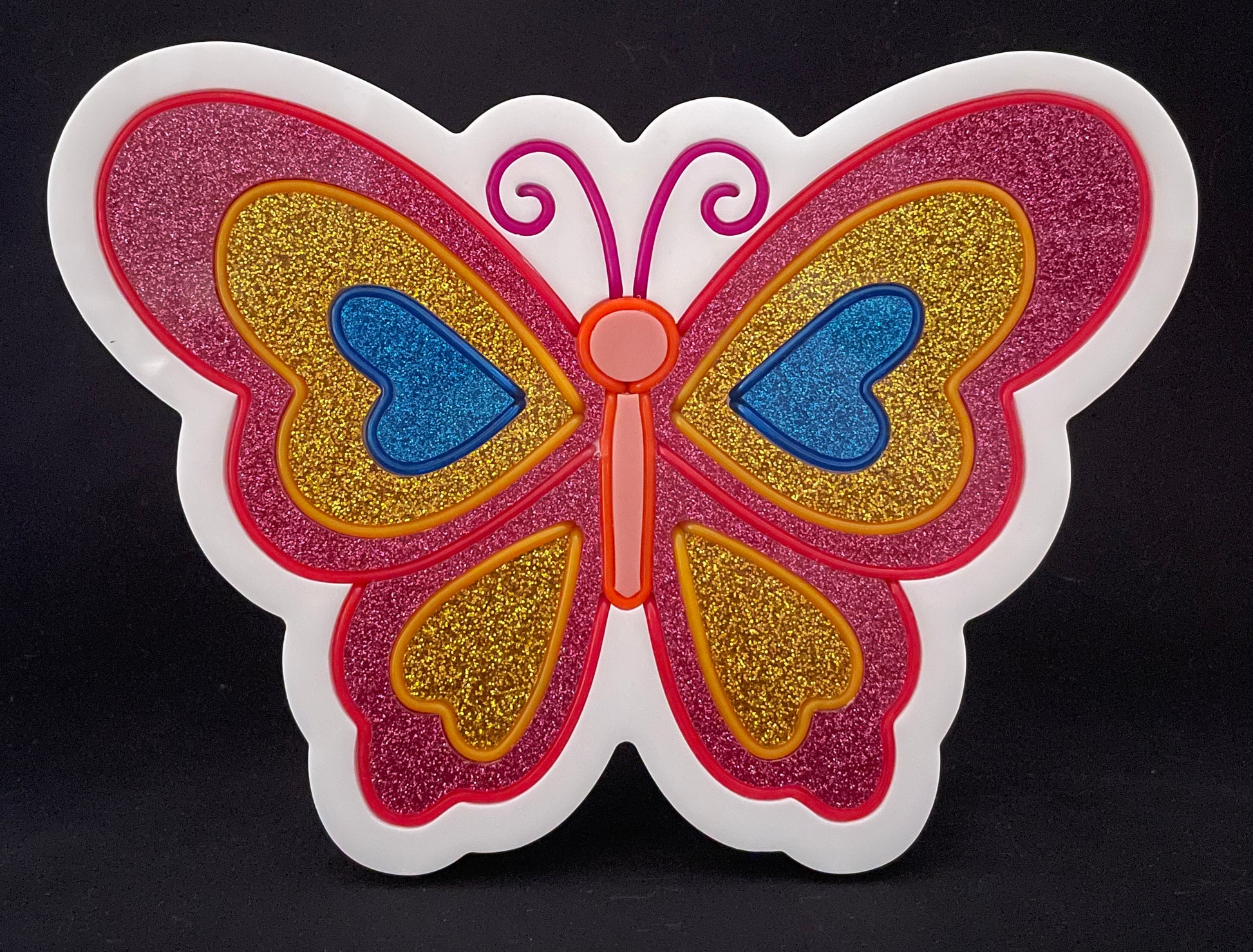 Pink, gold and blue butterfly with its wings open neon light not lit up