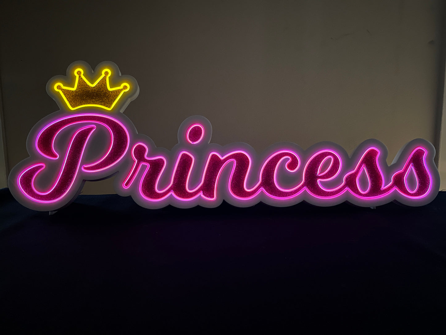 Princess neon name light in pink with a gold crown displayed lit up