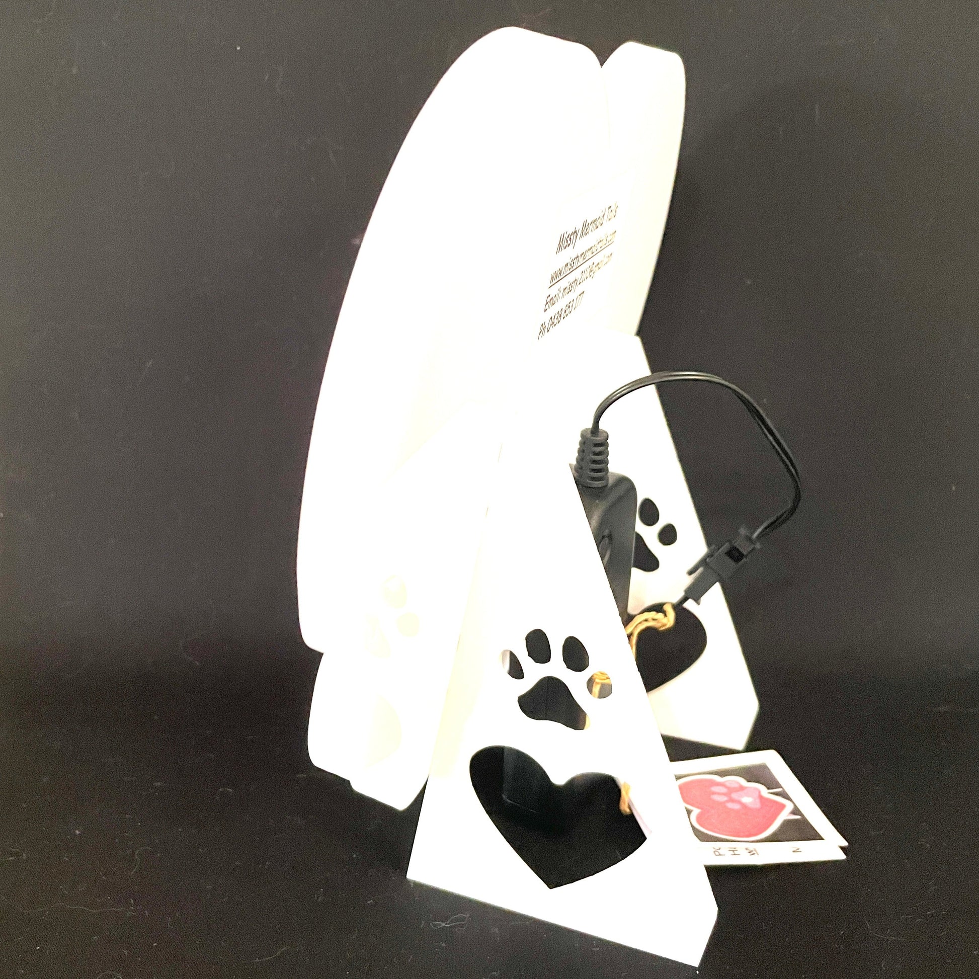 Side view of heart with paw print neon light