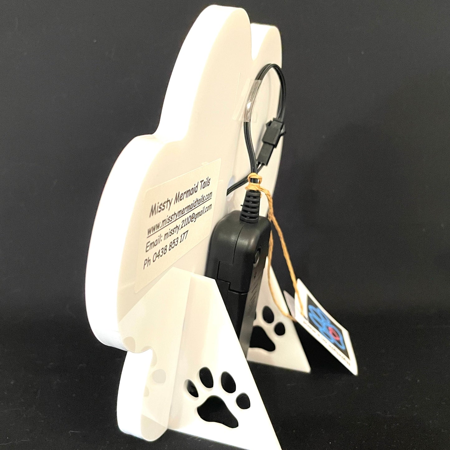 Side view of paw print neon light with a battery pack
